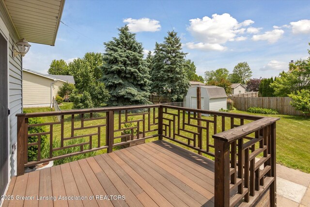 202 Kerry St, Eaton Rapids, MI 48827 - wooden terrace with a shed, a fenced backyard, and a garage