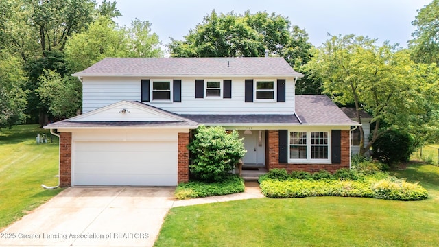 1965 Rutgers Cir, East Lansing, MI 48823 - view of front of property with brick siding, a front yard, driveway, an attached garage, and roof with shingles