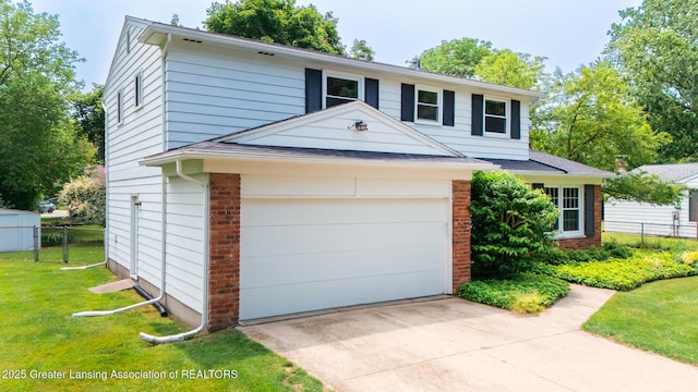 1965 Rutgers Cir, East Lansing, MI 48823 - view of front of property with brick siding, concrete driveway, and a garage