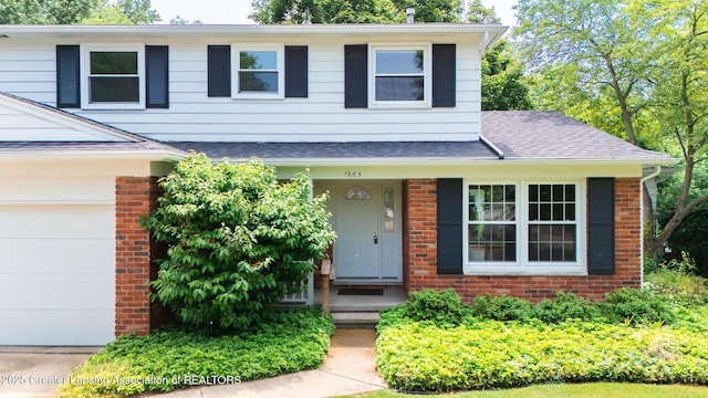 1965 Rutgers Cir, East Lansing, MI 48823 - view of front of property with brick siding and a shingled roof