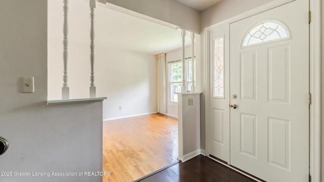 1965 Rutgers Cir, East Lansing, MI 48823 - foyer entrance featuring dark wood-style flooring and baseboards