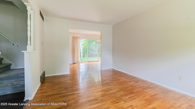 1965 Rutgers Cir, East Lansing, MI 48823 - spare room with light wood-type flooring and stairs