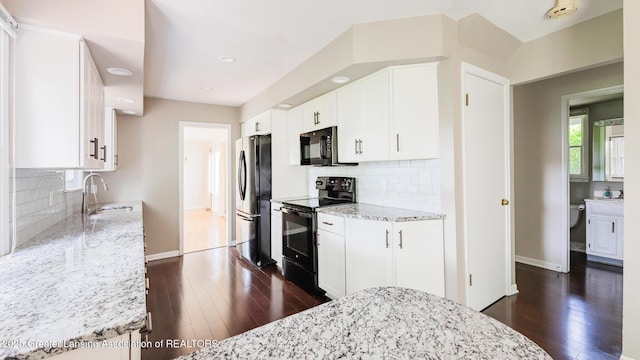 1965 Rutgers Cir, East Lansing, MI 48823 - kitchen with black appliances, dark wood-type flooring, light stone countertops, backsplash, and recessed lighting