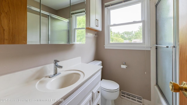 1965 Rutgers Cir, East Lansing, MI 48823 - full bath with baseboard heating, vanity, bath / shower combo with glass door, and tile patterned floors