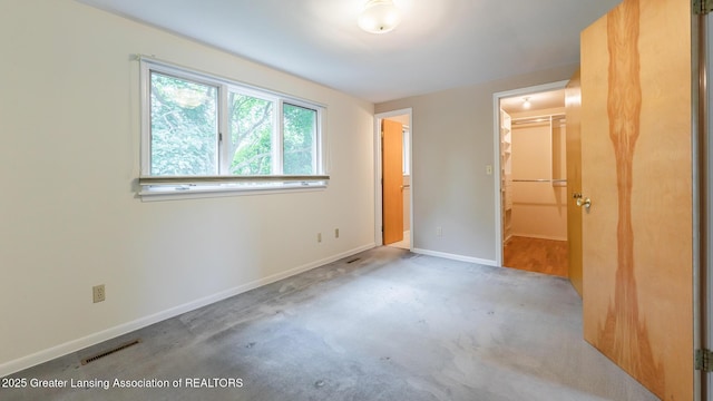 1965 Rutgers Cir, East Lansing, MI 48823 - unfurnished bedroom with a walk in closet and a closet