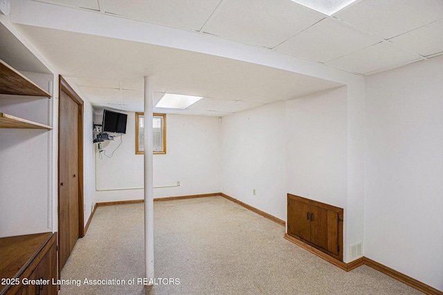 725 Center St, Mason, MI 48854 - basement featuring a drop ceiling and light carpet