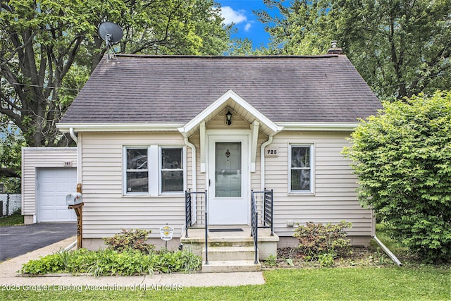 725 Center St, Mason, MI 48854 - view of front of house with roof with shingles and asphalt driveway