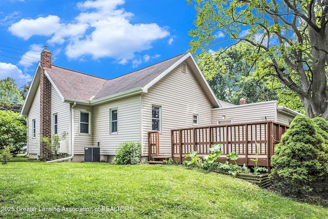 725 Center St, Mason, MI 48854 - view of home's exterior featuring a chimney, a yard, a shingled roof, and a wooden deck