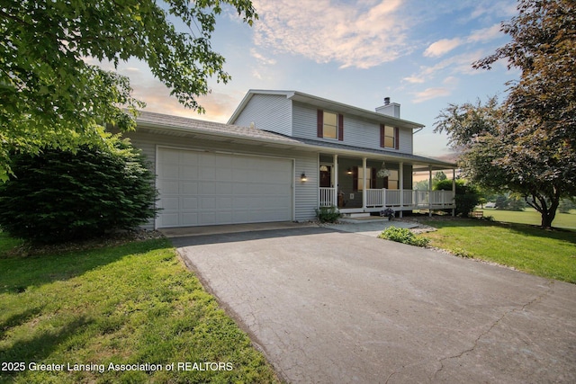 921 Ives Rd, Mason, MI 48854 - view of front facade with covered porch, a chimney, asphalt driveway, a yard, and a garage