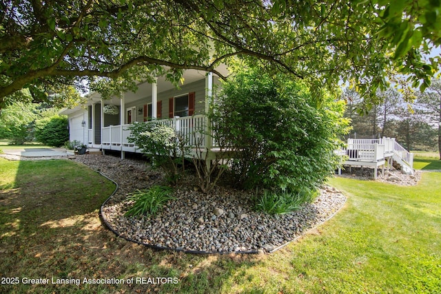 921 Ives Rd, Mason, MI 48854 - view of property exterior with a porch, a yard, and an attached garage