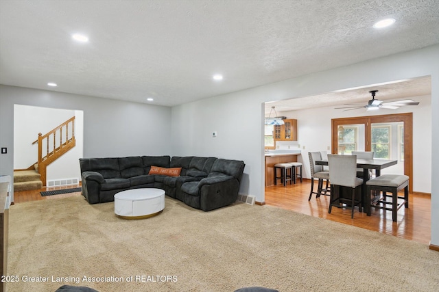 921 Ives Rd, Mason, MI 48854 - carpeted living area featuring recessed lighting, stairway, and ceiling fan