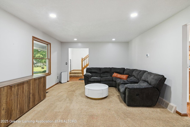 921 Ives Rd, Mason, MI 48854 - living room featuring light colored carpet, recessed lighting, stairs, and baseboards