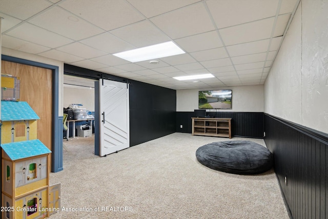 921 Ives Rd, Mason, MI 48854 - finished basement with wainscoting, carpet, and a paneled ceiling