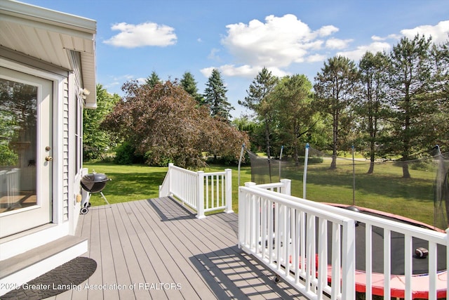 921 Ives Rd, Mason, MI 48854 - wooden terrace with a lawn, entry steps, view of wooded area, and grilling area