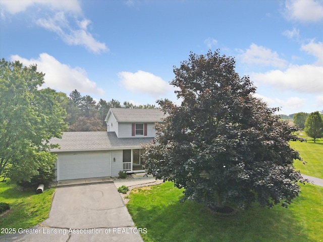 921 Ives Rd, Mason, MI 48854 - view of front of house with driveway, an attached garage, and a front lawn
