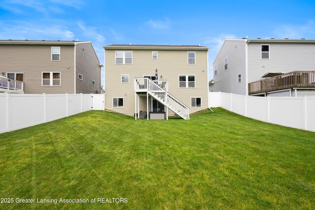 15925 Turnberry St, Lansing, MI 48906 - back of house with stairs, a fenced backyard, and a wooden deck