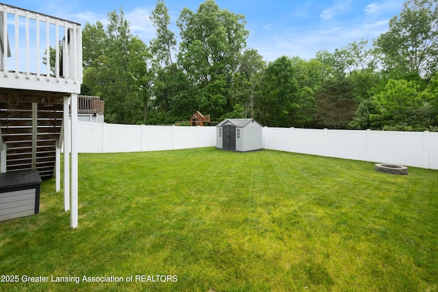 15925 Turnberry St, Lansing, MI 48906 - fenced backyard with a shed, an outdoor fire pit, stairs, and a deck