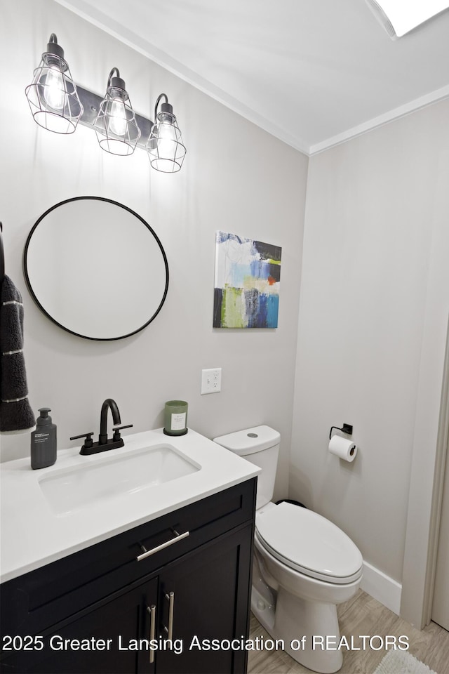 15925 Turnberry St, Lansing, MI 48906 - bathroom with vanity, wood finished floors, and crown molding
