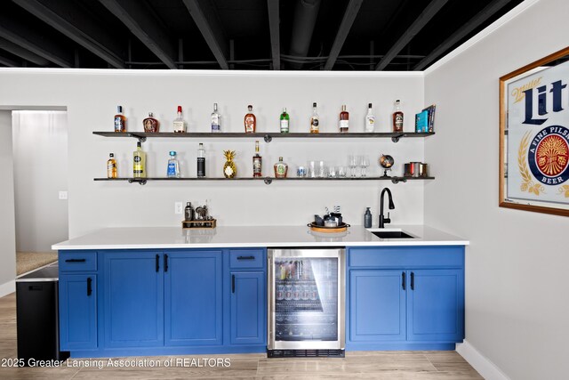 15925 Turnberry St, Lansing, MI 48906 - indoor wet bar with beverage cooler and light wood finished floors