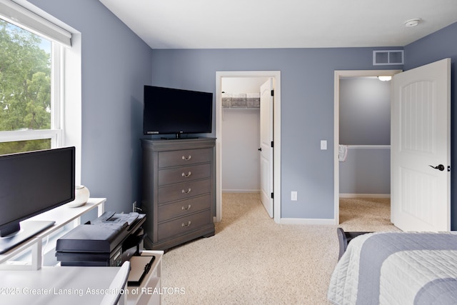 15925 Turnberry St, Lansing, MI 48906 - bedroom with a walk in closet, light colored carpet, and a closet