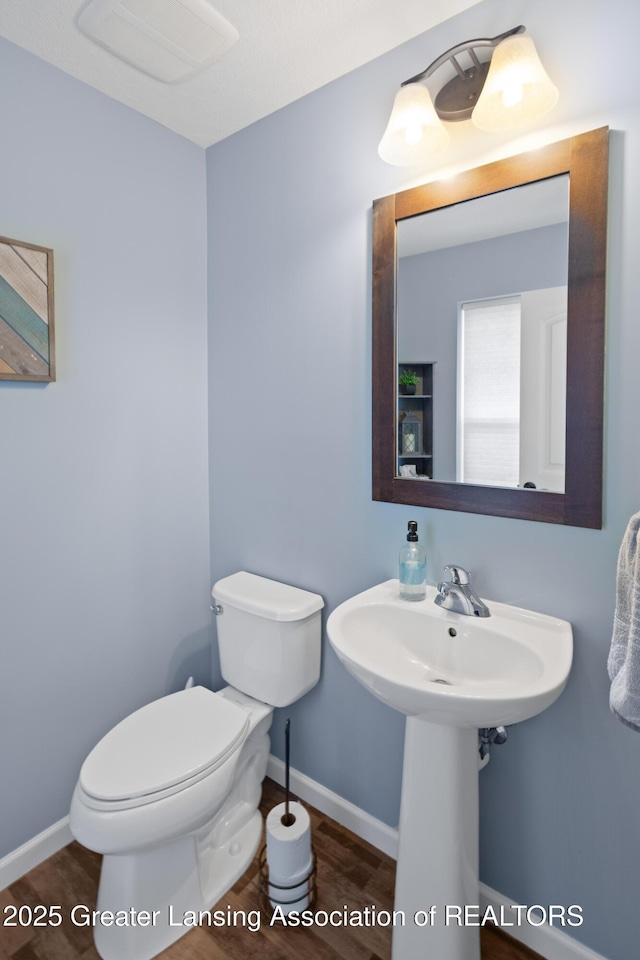 15925 Turnberry St, Lansing, MI 48906 - half bathroom with toilet and wood finished floors