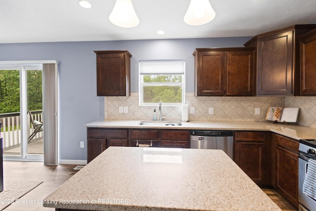 15925 Turnberry St, Lansing, MI 48906 - kitchen with stainless steel appliances, plenty of natural light, dark brown cabinetry, and recessed lighting