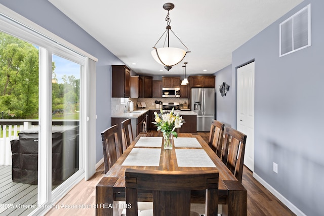 15925 Turnberry St, Lansing, MI 48906 - dining room featuring light wood-style floors and baseboards