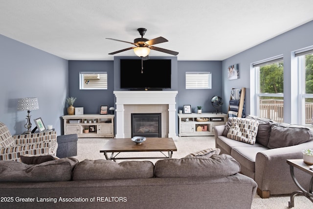 15925 Turnberry St, Lansing, MI 48906 - carpeted living room featuring a ceiling fan and a glass covered fireplace