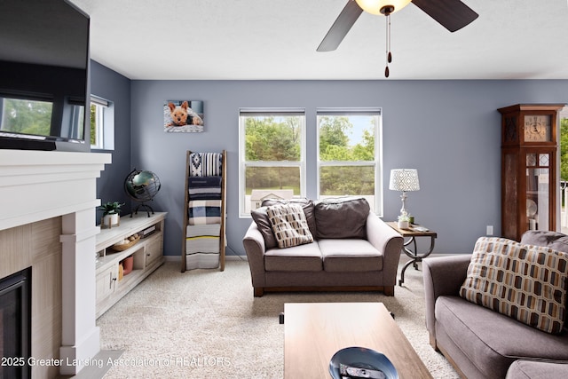 15925 Turnberry St, Lansing, MI 48906 - living room with light carpet, a ceiling fan, and a glass covered fireplace