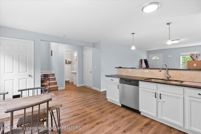 460 Blue Spruce Ln, Mason, MI 48854 - kitchen featuring stainless steel dishwasher, light wood finished floors, white cabinets, and tasteful backsplash