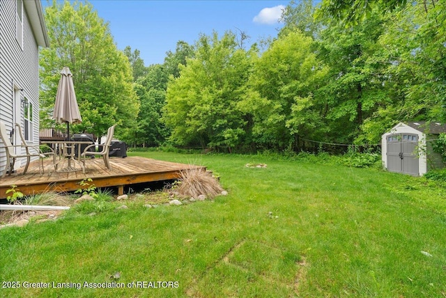 460 Blue Spruce Ln, Mason, MI 48854 - view of green lawn featuring a storage shed, a wooden deck, and outdoor dining space