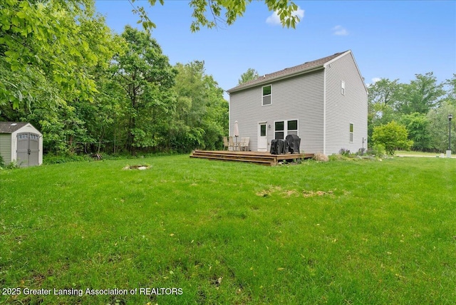 460 Blue Spruce Ln, Mason, MI 48854 - rear view of property featuring a storage unit, a wooden deck, and a yard