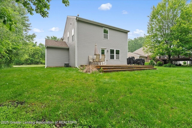460 Blue Spruce Ln, Mason, MI 48854 - rear view of house with a wooden deck and a yard