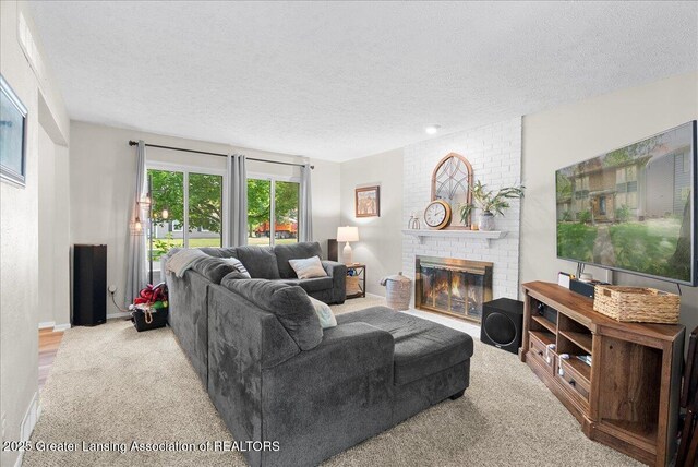 992 Touraine Ave, East Lansing, MI 48823 - carpeted living room featuring a textured ceiling, a brick fireplace, and baseboards