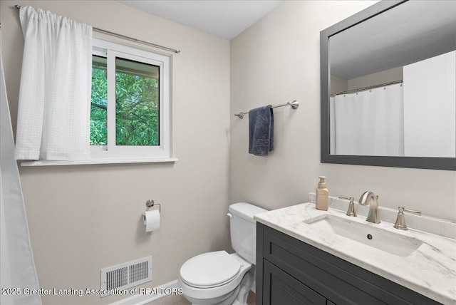 992 Touraine Ave, East Lansing, MI 48823 - bathroom featuring vanity, toilet, and baseboards