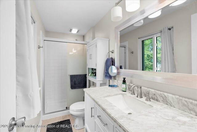 992 Touraine Ave, East Lansing, MI 48823 - full bath with vanity, a stall shower, and toilet