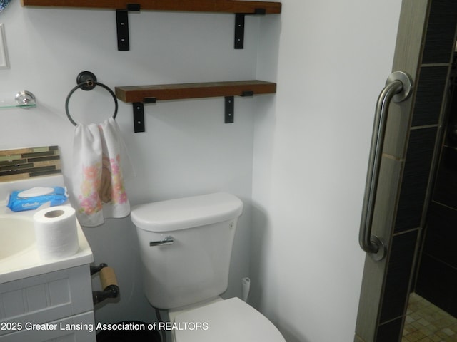 161 Okemos Rd, Mason, MI 48854 - bathroom featuring toilet, vanity, and a shower
