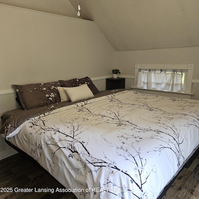 405 E Shaw St, Charlotte, MI 48813 - bedroom featuring lofted ceiling, wood finished floors, and wainscoting