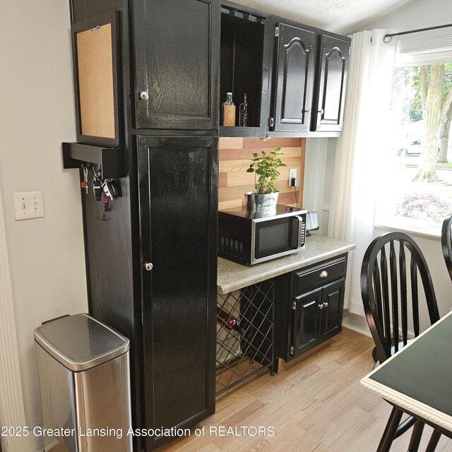 405 E Shaw St, Charlotte, MI 48813 - bar featuring stainless steel microwave and light wood-type flooring