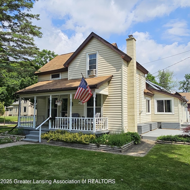 405 E Shaw St, Charlotte, MI 48813 - view of front of home with a chimney, a front lawn, and a porch