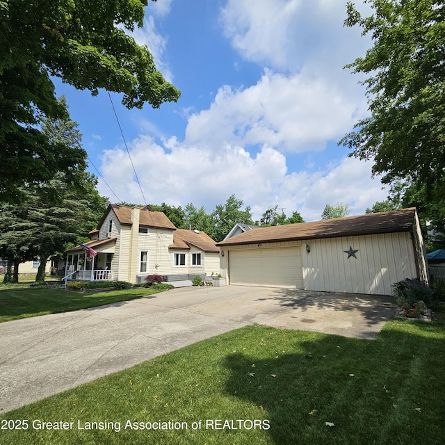 405 E Shaw St, Charlotte, MI 48813 - view of front of home with a front lawn, an outbuilding, and a garage