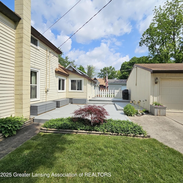 405 E Shaw St, Charlotte, MI 48813 - view of grassy yard with driveway and a patio area