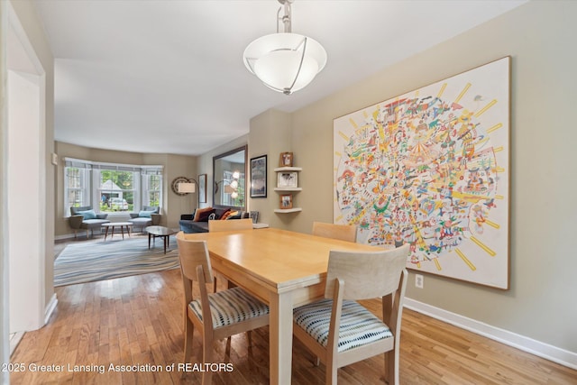 932 Sunset Ln, East Lansing, MI 48823 - dining area featuring baseboards and light wood-style floors