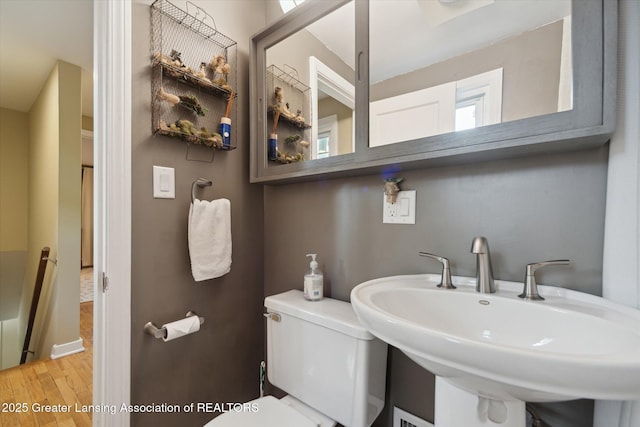 932 Sunset Ln, East Lansing, MI 48823 - half bath featuring a sink and wood finished floors