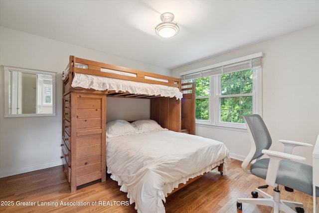 932 Sunset Ln, East Lansing, MI 48823 - bedroom featuring wood finished floors and baseboards