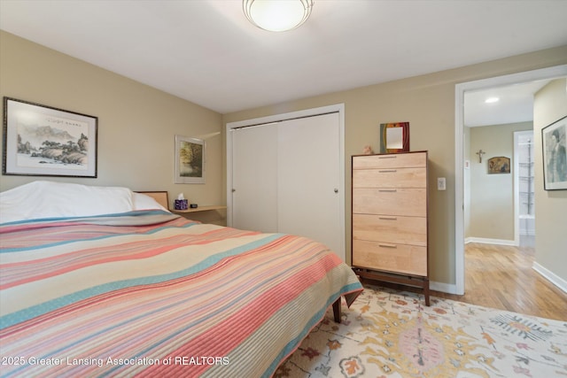 932 Sunset Ln, East Lansing, MI 48823 - bedroom with a closet and light wood-type flooring