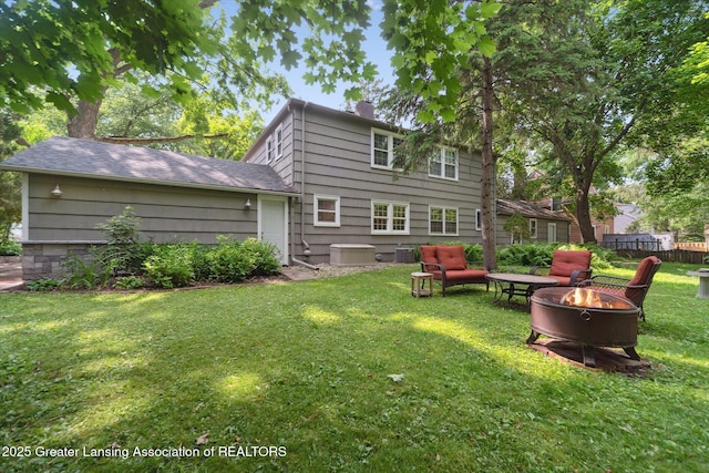 932 Sunset Ln, East Lansing, MI 48823 - rear view of property with an outdoor fire pit and a chimney