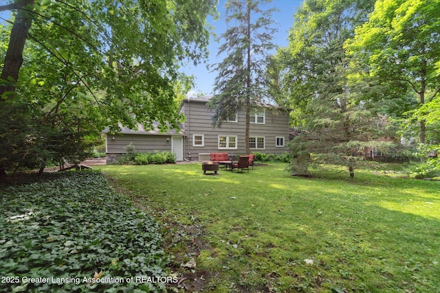 932 Sunset Ln, East Lansing, MI 48823 - rear view of property with a lawn