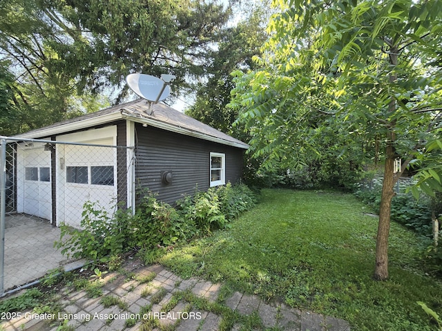 812 Westmoreland Ave, Lansing, MI 48915 - view of side of home featuring a lawn, a shingled roof, and a patio
