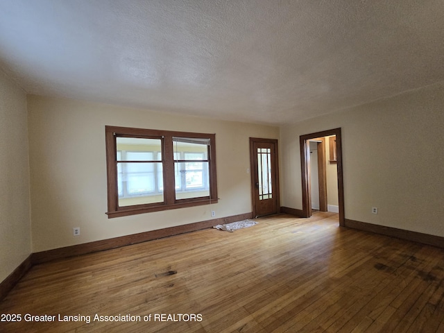 812 Westmoreland Ave, Lansing, MI 48915 - spare room with hardwood / wood-style floors, a textured ceiling, and baseboards